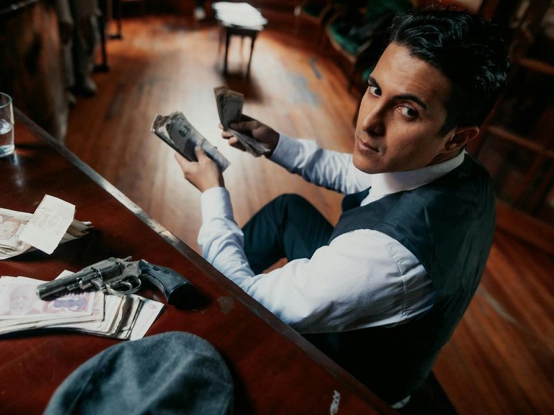 Man exercising with intense focus in a dark room.