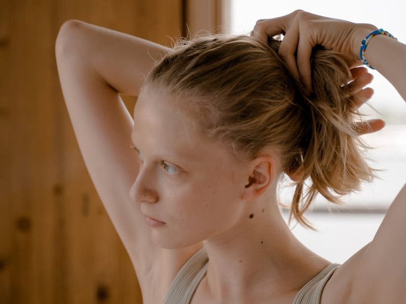 Person in a calm, focused state in a minimalist room.